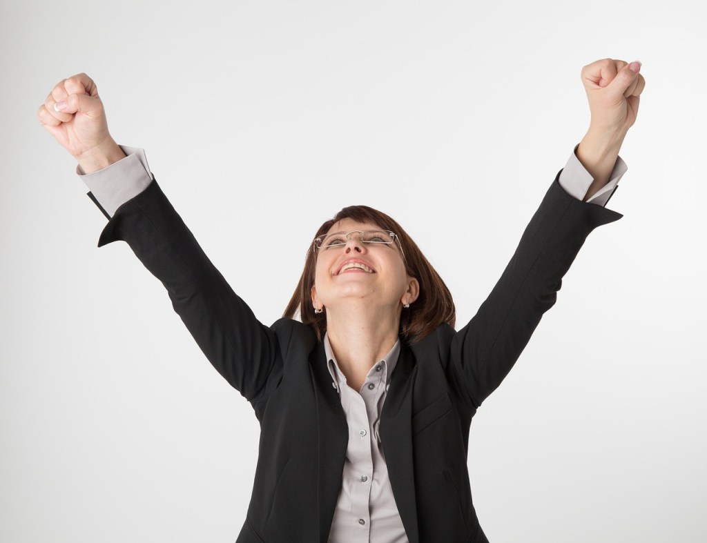 A women celebrating success when trying to achive relationship goals